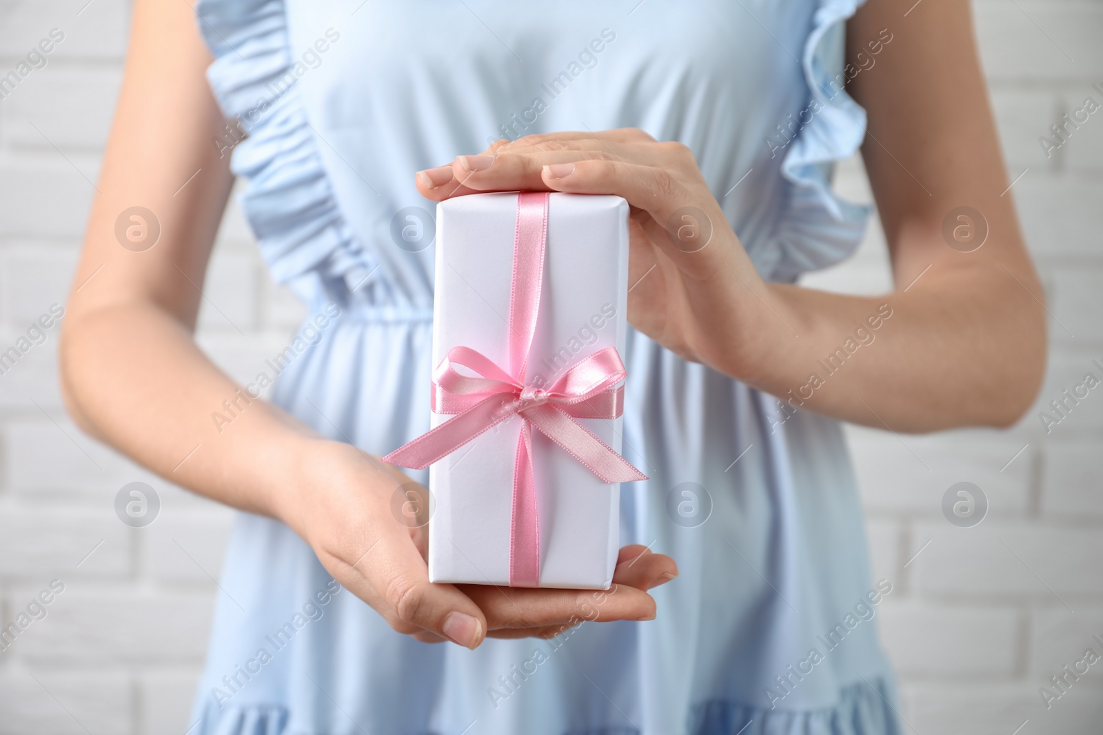 Photo of Woman holding beautiful gift box, closeup