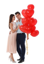 Beautiful couple with heart shaped balloons on white background