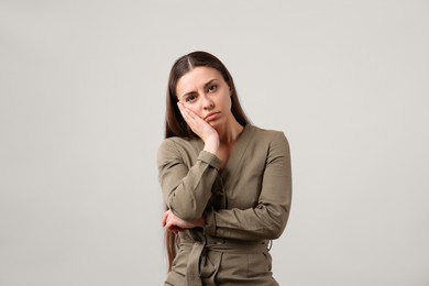 Portrait of young woman on light grey background. Personality concept