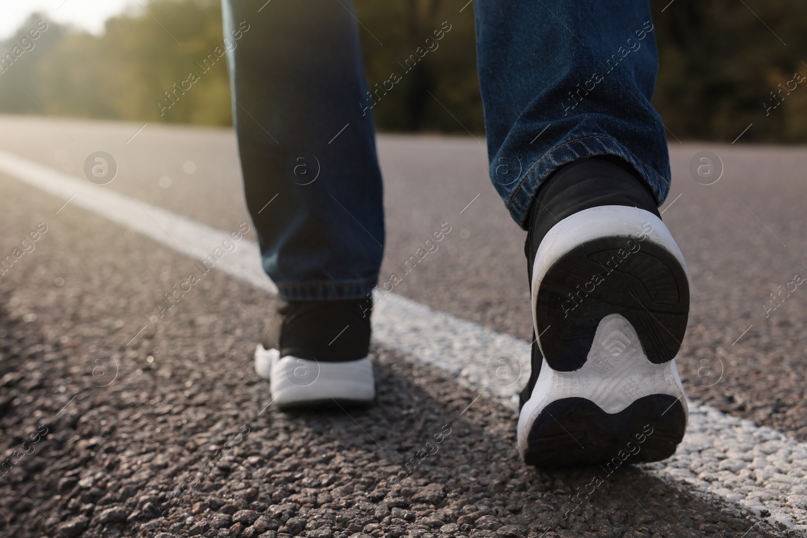 Photo of Man going along road, closeup of legs