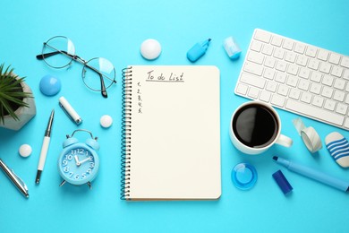 Photo of Flat lay composition with unfilled To Do list, computer keyboard and cup of coffee on light blue background