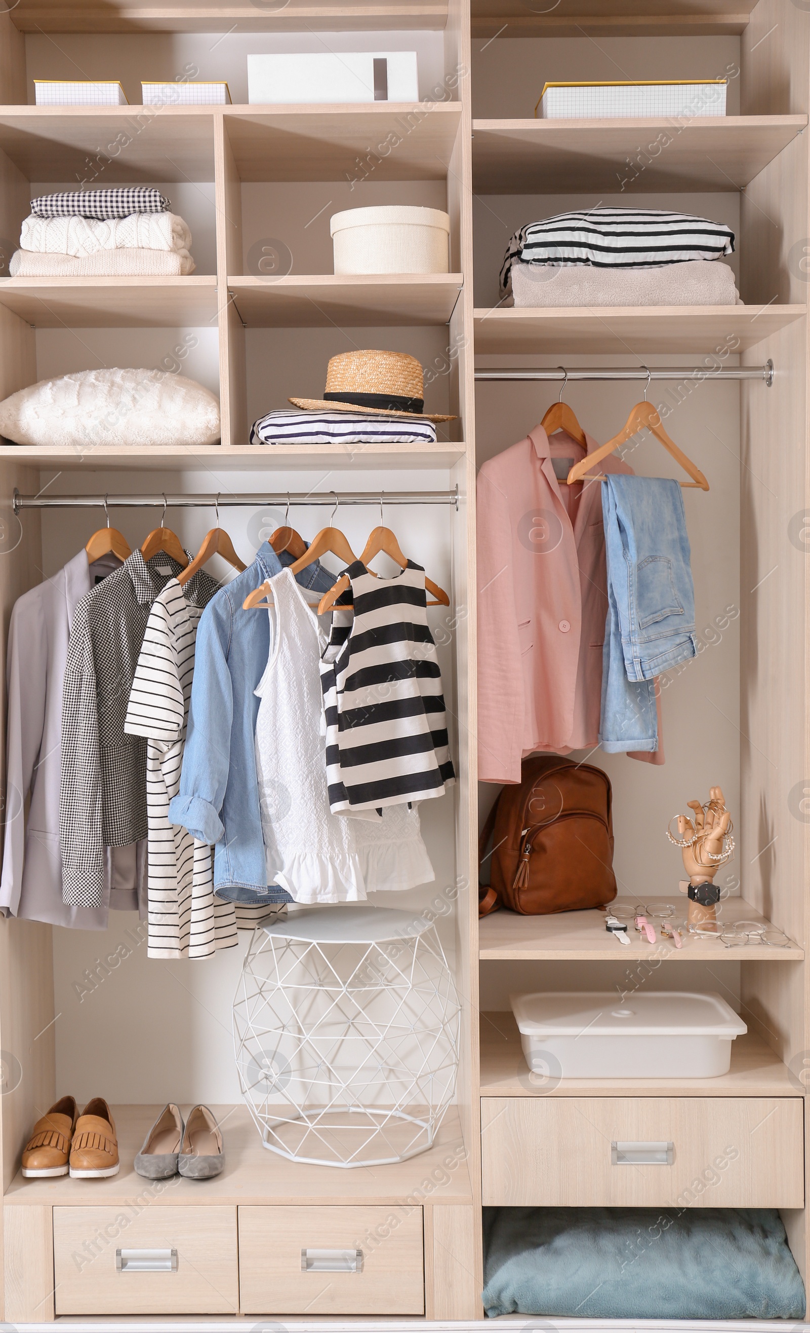 Photo of Stylish clothes, shoes and home stuff in large wardrobe closet