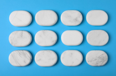 Photo of Spa stones on color background, flat lay