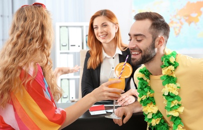 Photo of Beautiful young couple visiting travel agency office