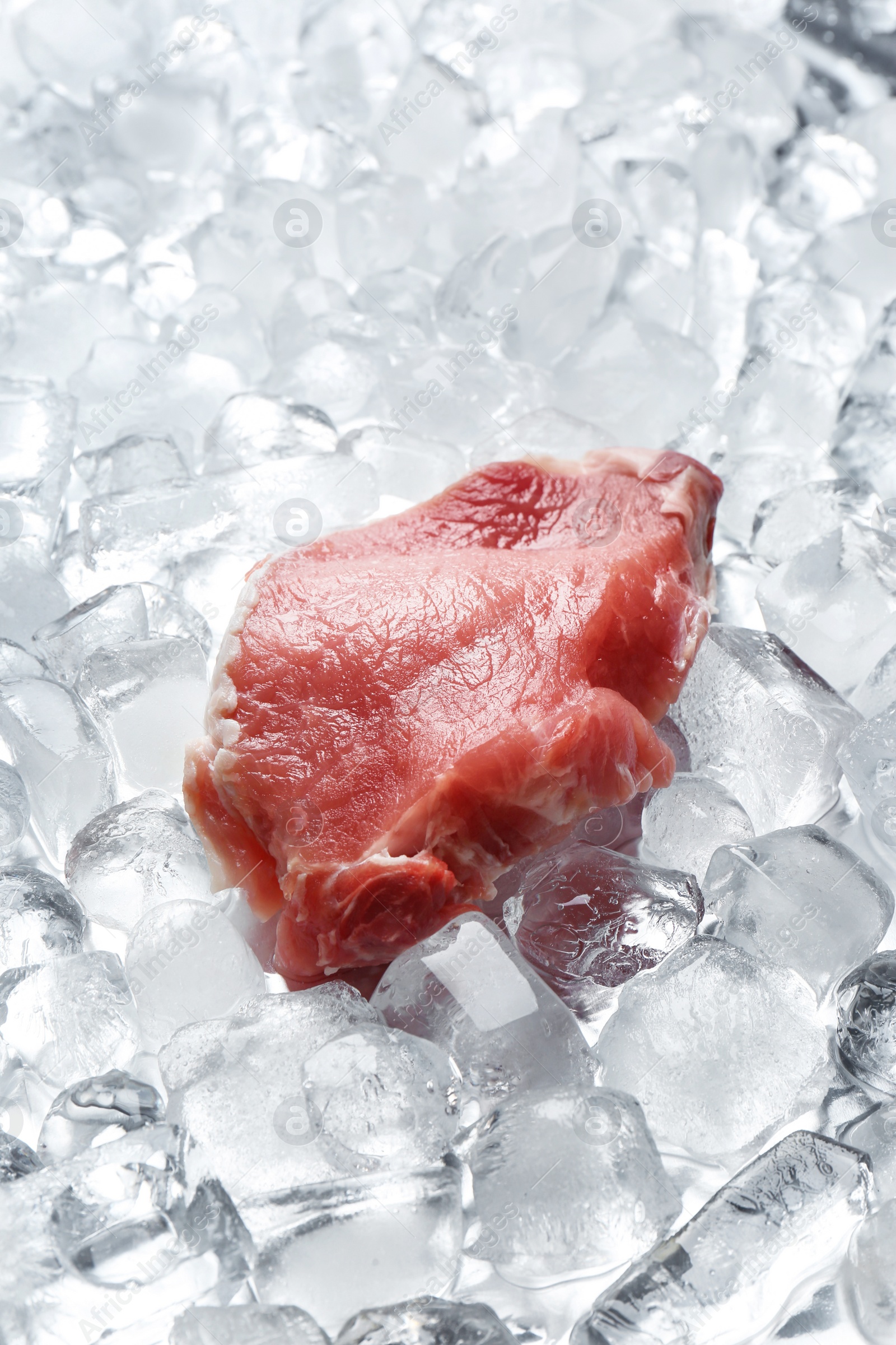 Photo of Piece of fresh raw meat on ice cubes