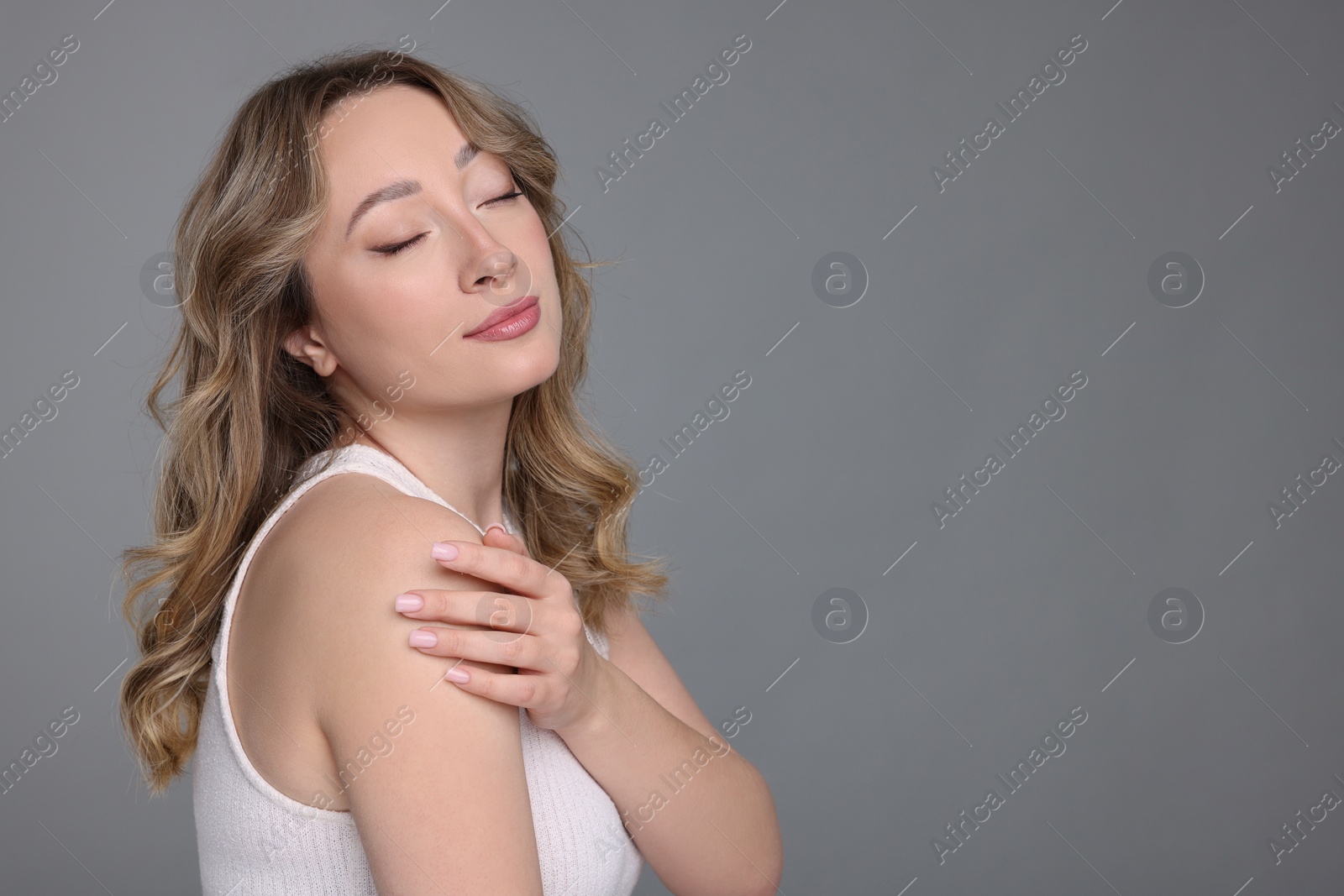 Photo of Portrait of beautiful woman on grey background. Space for text