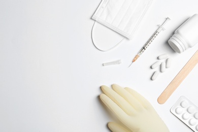 Flat lay composition with medical glove on white background. Space for text