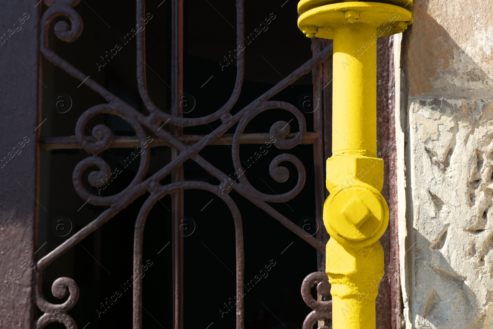 Photo of Yellow gas pipe near old wall outdoors, space for text