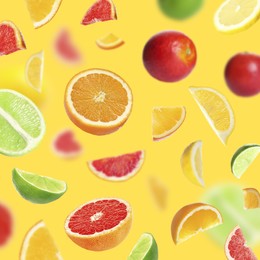 Fresh juicy citrus fruits on yellow background