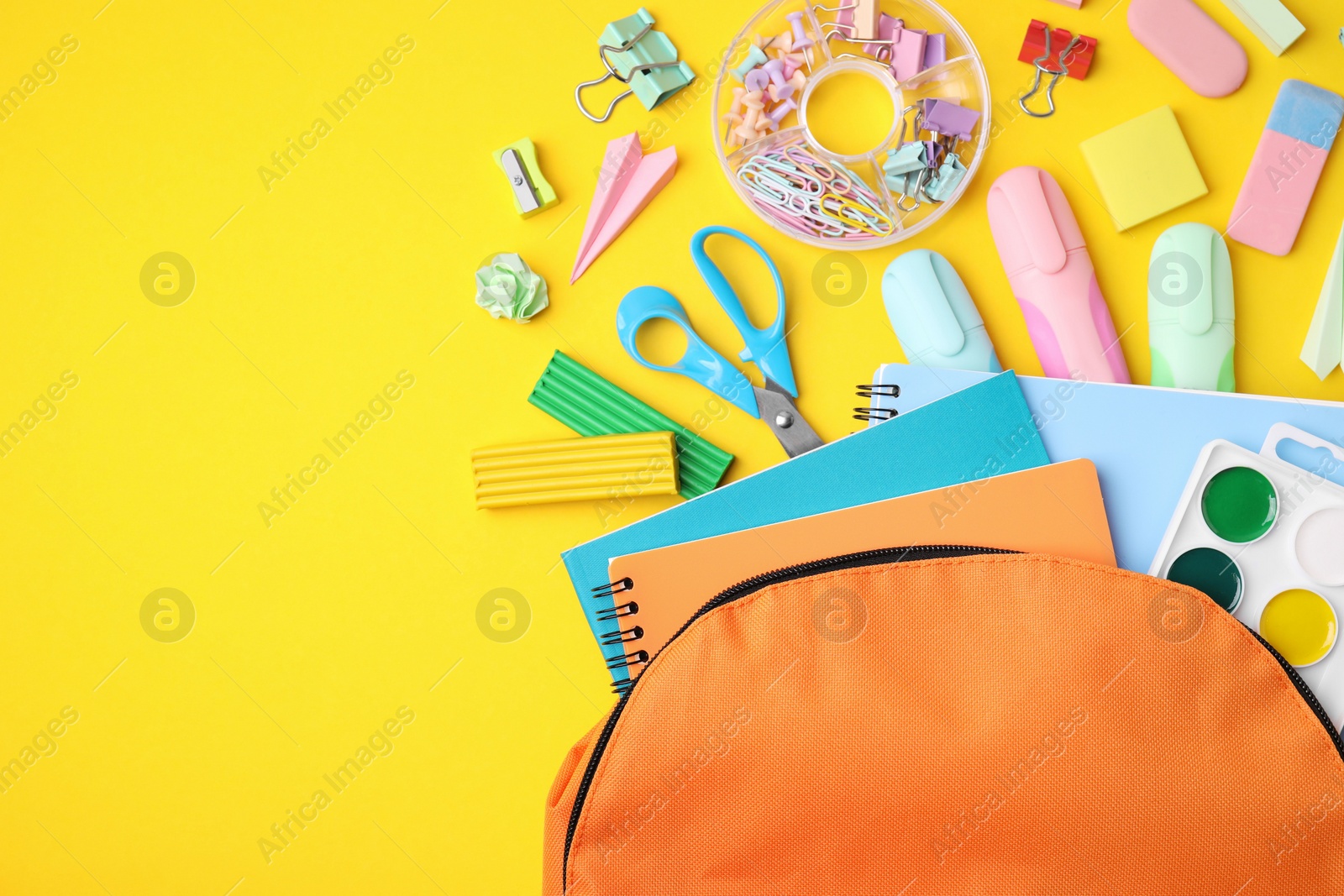 Photo of Flat lay composition with different school stationery on yellow background, space for text. Back to school