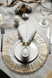 Easter table setting with bunny ears made of egg and napkin, above view