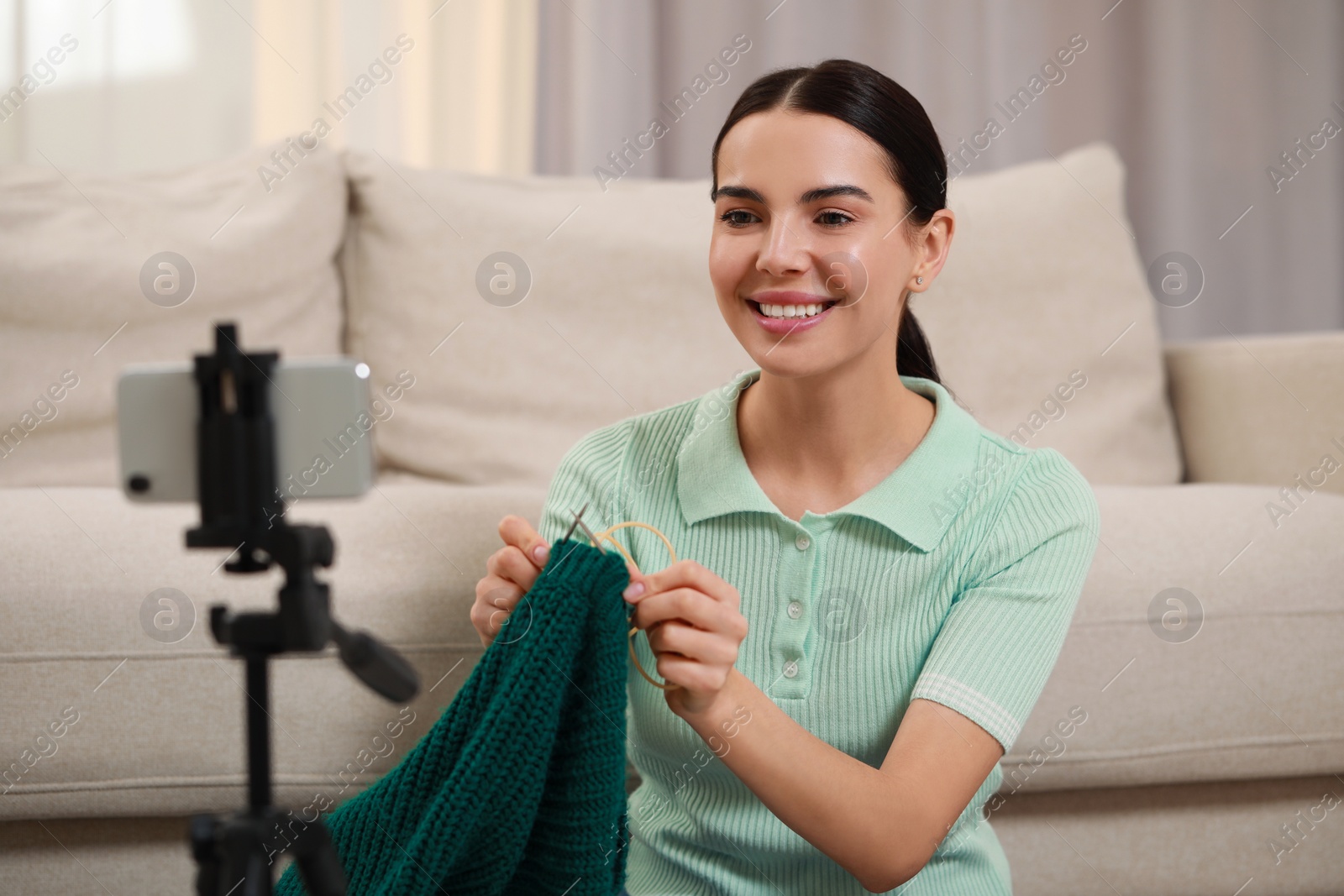 Photo of Teacher conducting online knitting course at home. Time for hobby