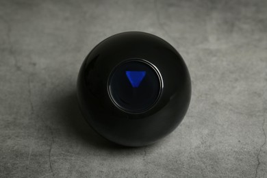 Photo of One magic eight ball on grey table