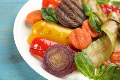 Photo of Delicious grilled vegetables with basil on plate, closeup