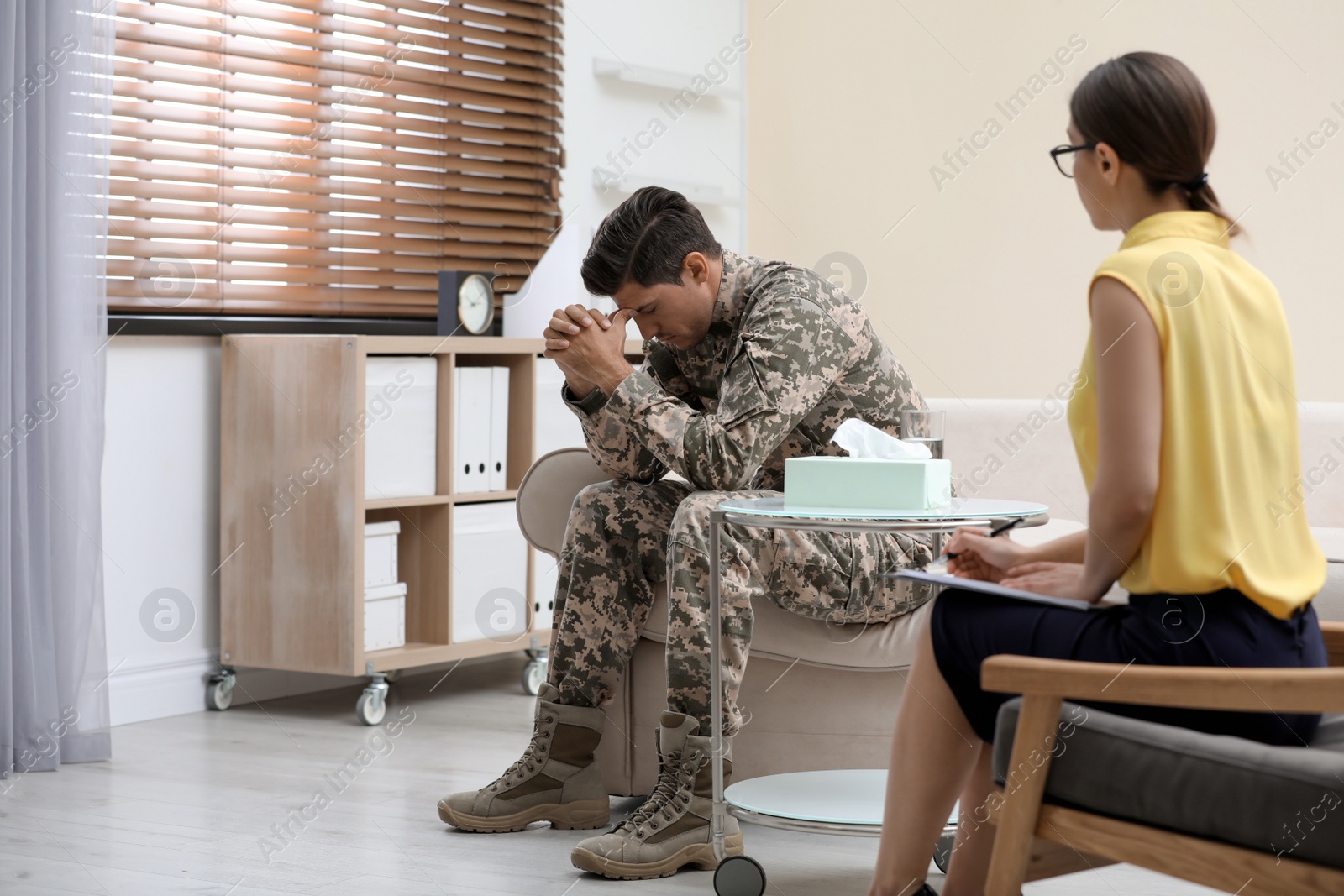 Photo of Psychotherapist working with male military officer in office