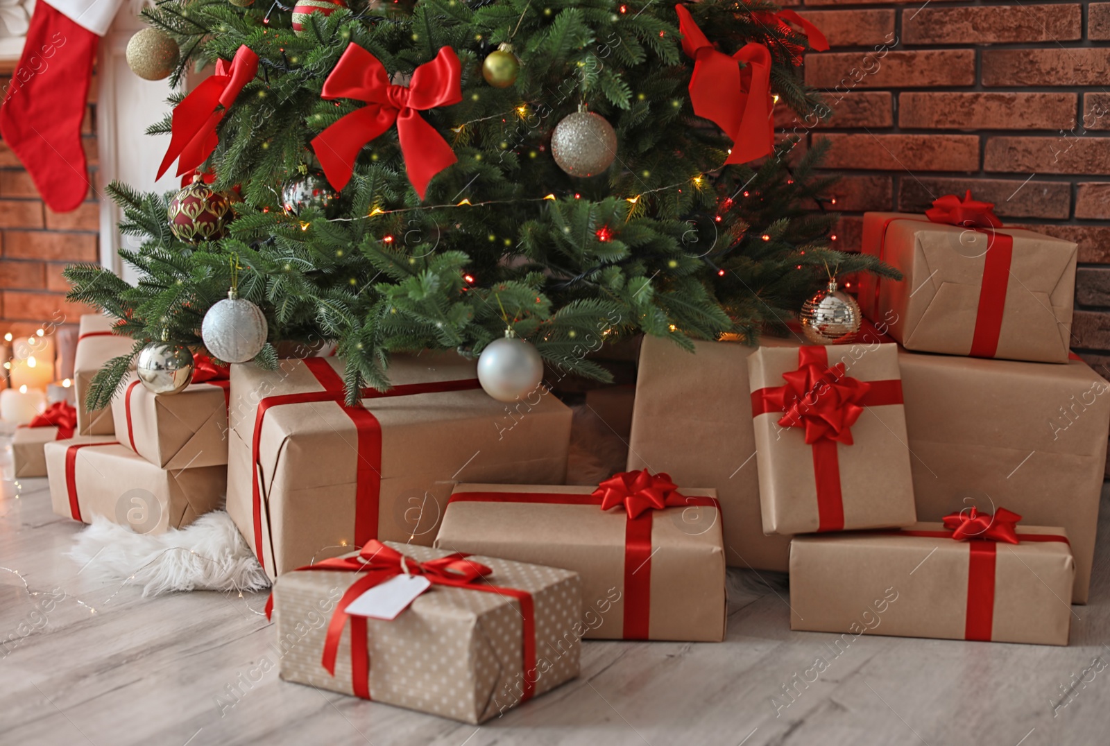 Photo of Beautiful Christmas tree and gift boxes in room