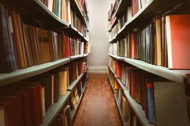 Collection of different books on shelves in library