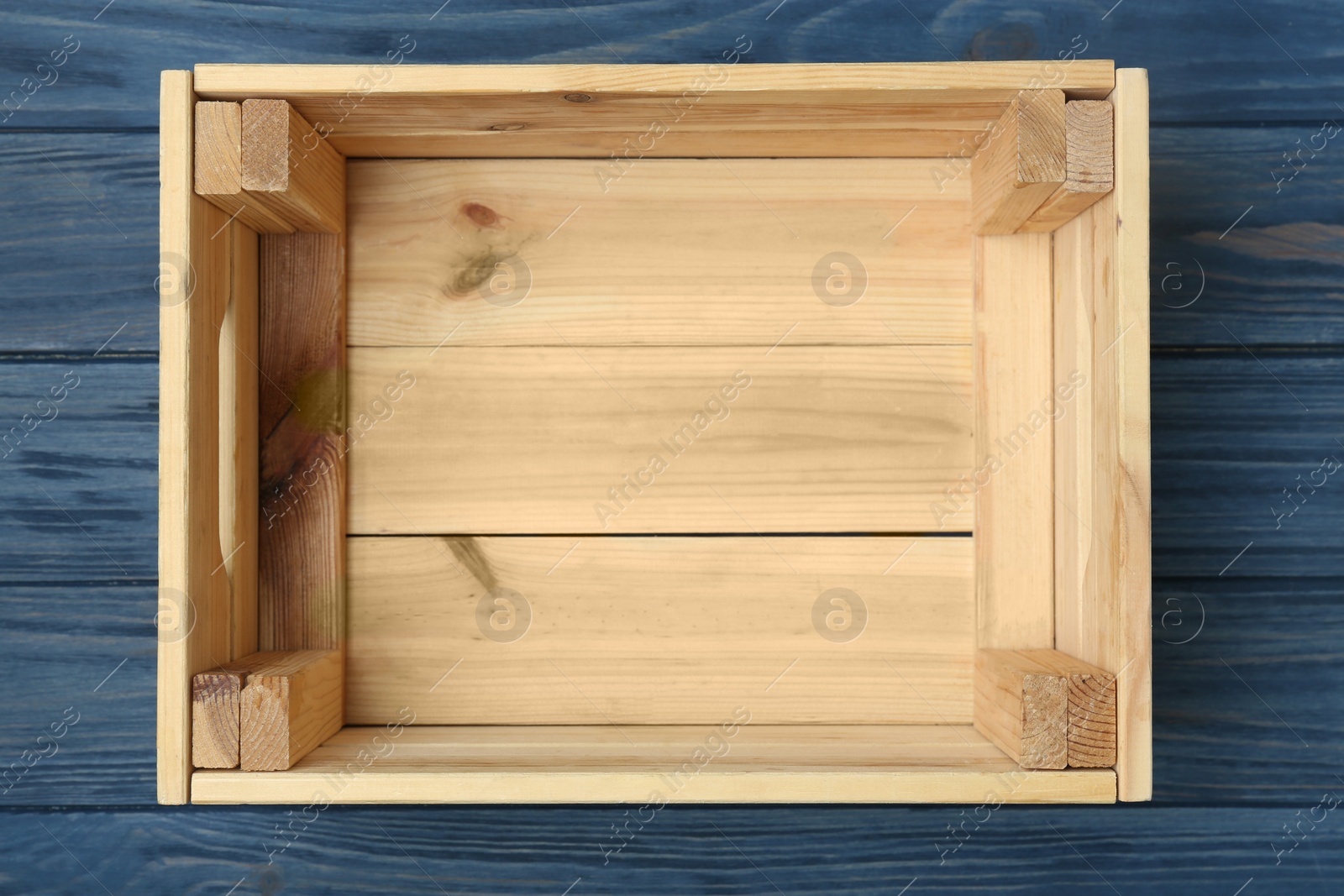 Photo of Empty wooden crate on color background, top view