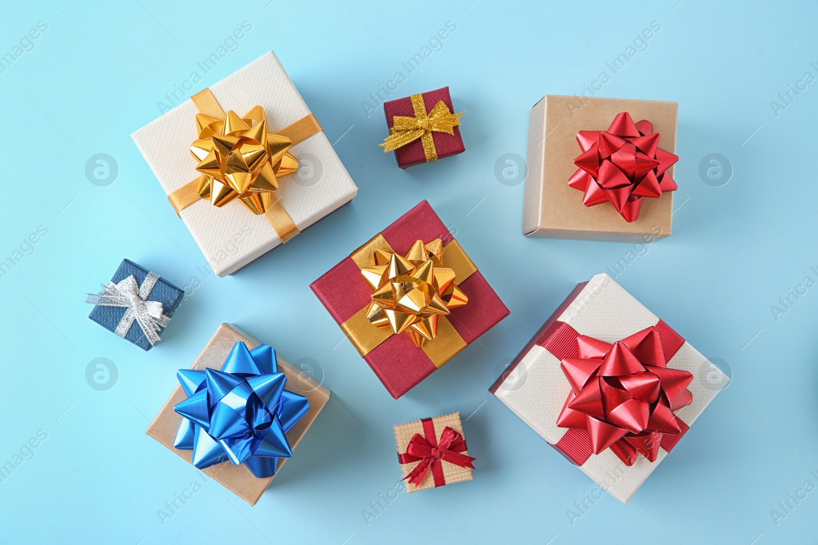 Photo of Flat lay composition with beautiful gift boxes on blue background