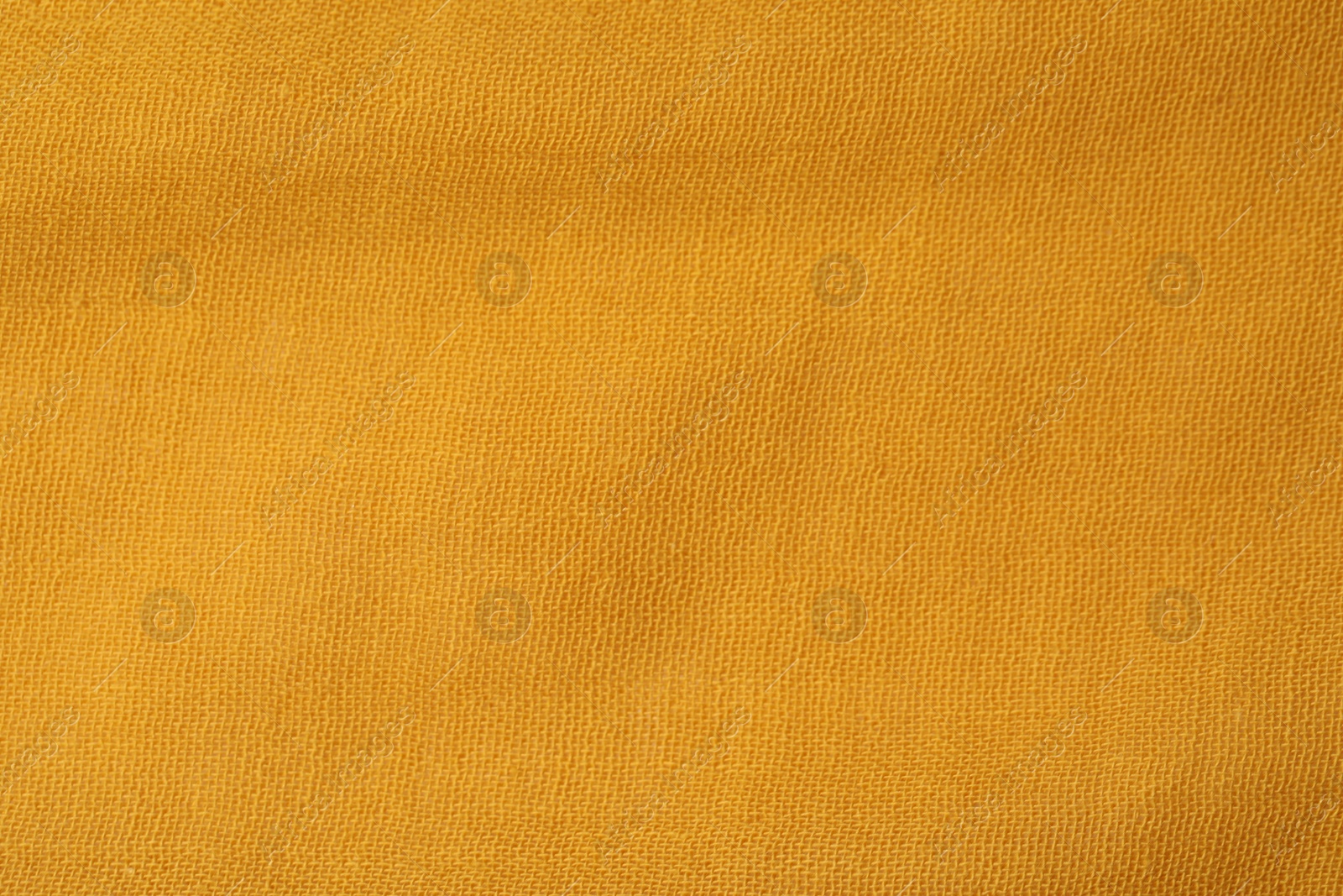 Photo of Texture of bright orange fabric as background, top view