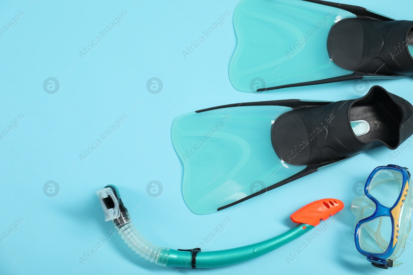 Photo of Different sports equipment on light blue background, flat lay. Space for text