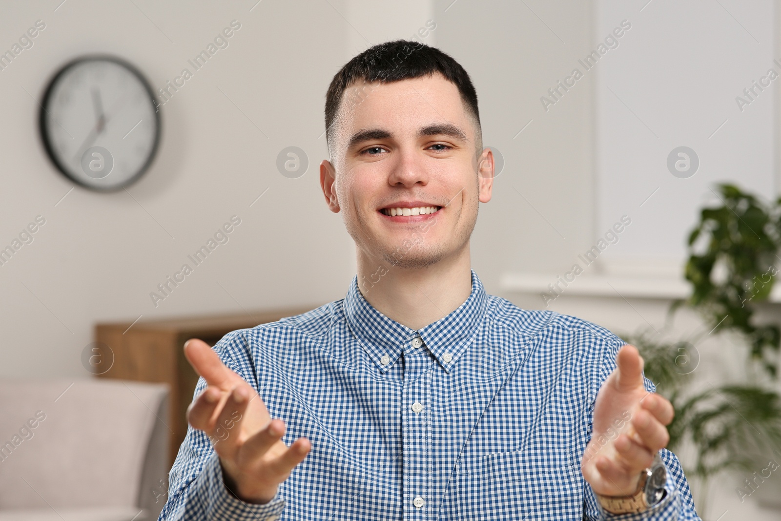 Photo of Young man having online video call at home, view from web camera