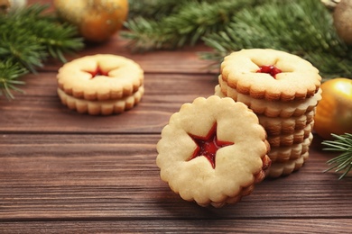 Traditional Christmas Linzer cookies with sweet jam on wooden table