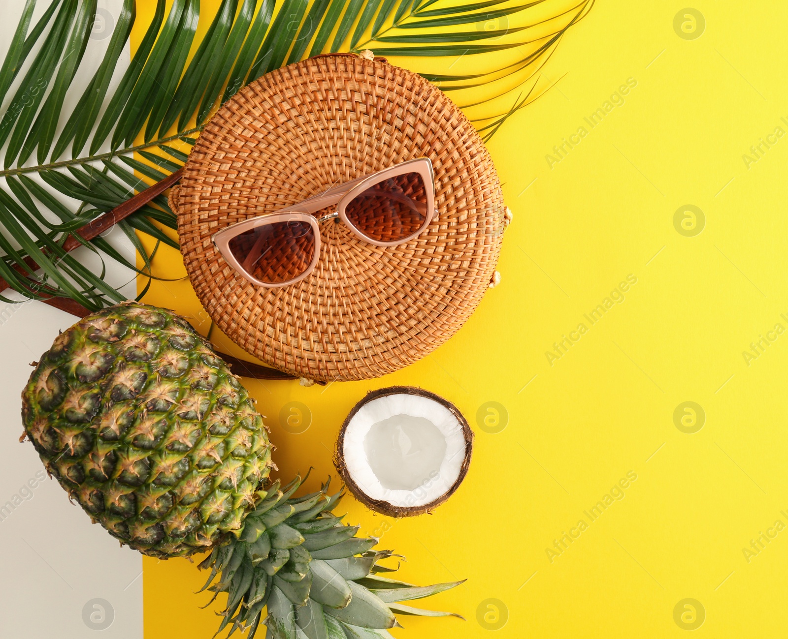 Photo of Flat lay composition with bamboo bag, beach items and space for text on color background