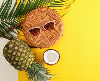 Photo of Flat lay composition with bamboo bag, beach items and space for text on color background