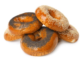 Many delicious fresh bagels on white background