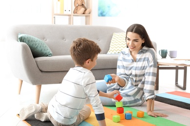 Child psychologist working with boy in office