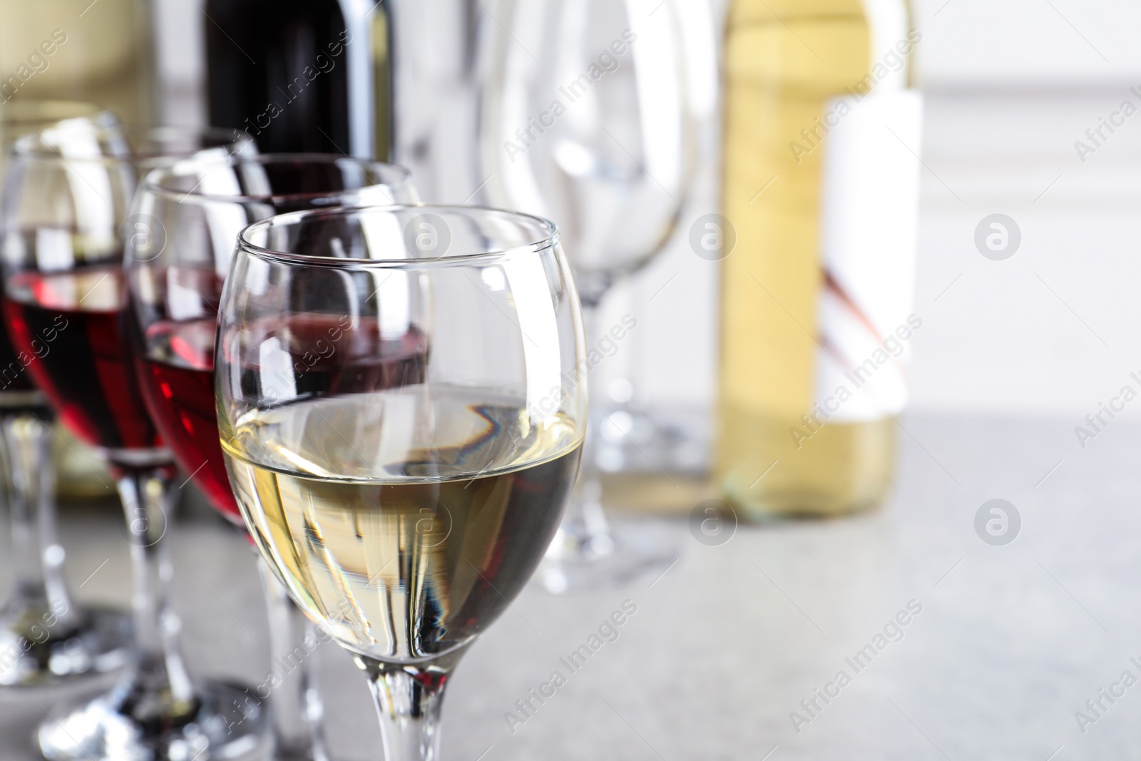 Photo of Elegant glasses with delicious wine on table