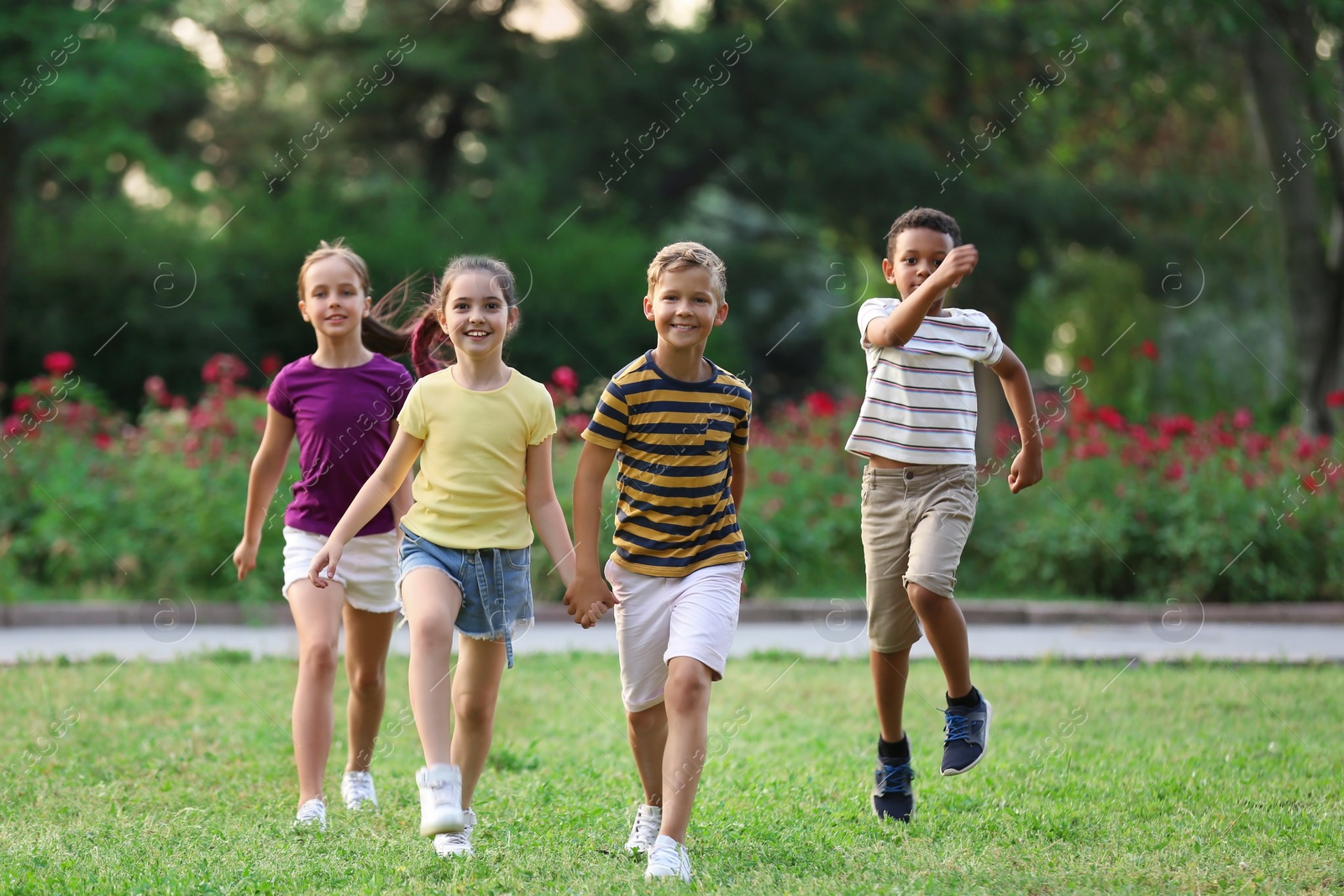 Photo of Cute smiling little children playing in park