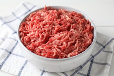 Raw ground meat in bowl on table, closeup