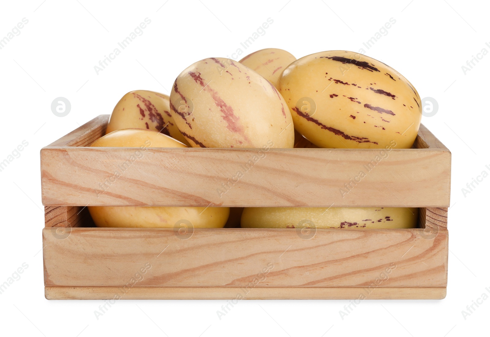 Photo of Fresh ripe pepino melons in wooden crate on white background