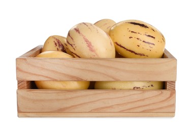 Fresh ripe pepino melons in wooden crate on white background