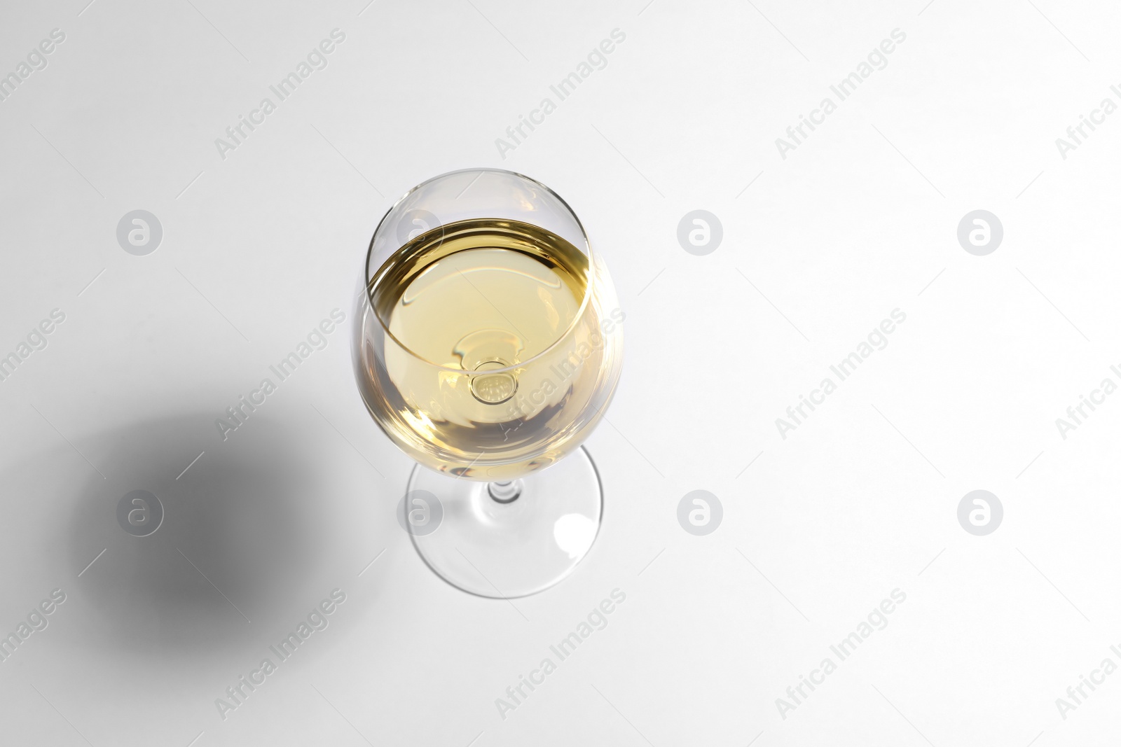 Photo of Glass of wine on white background, above view. Space for text