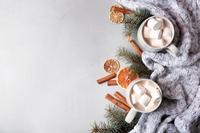 Flat lay composition with hot cocoa drink on grey background