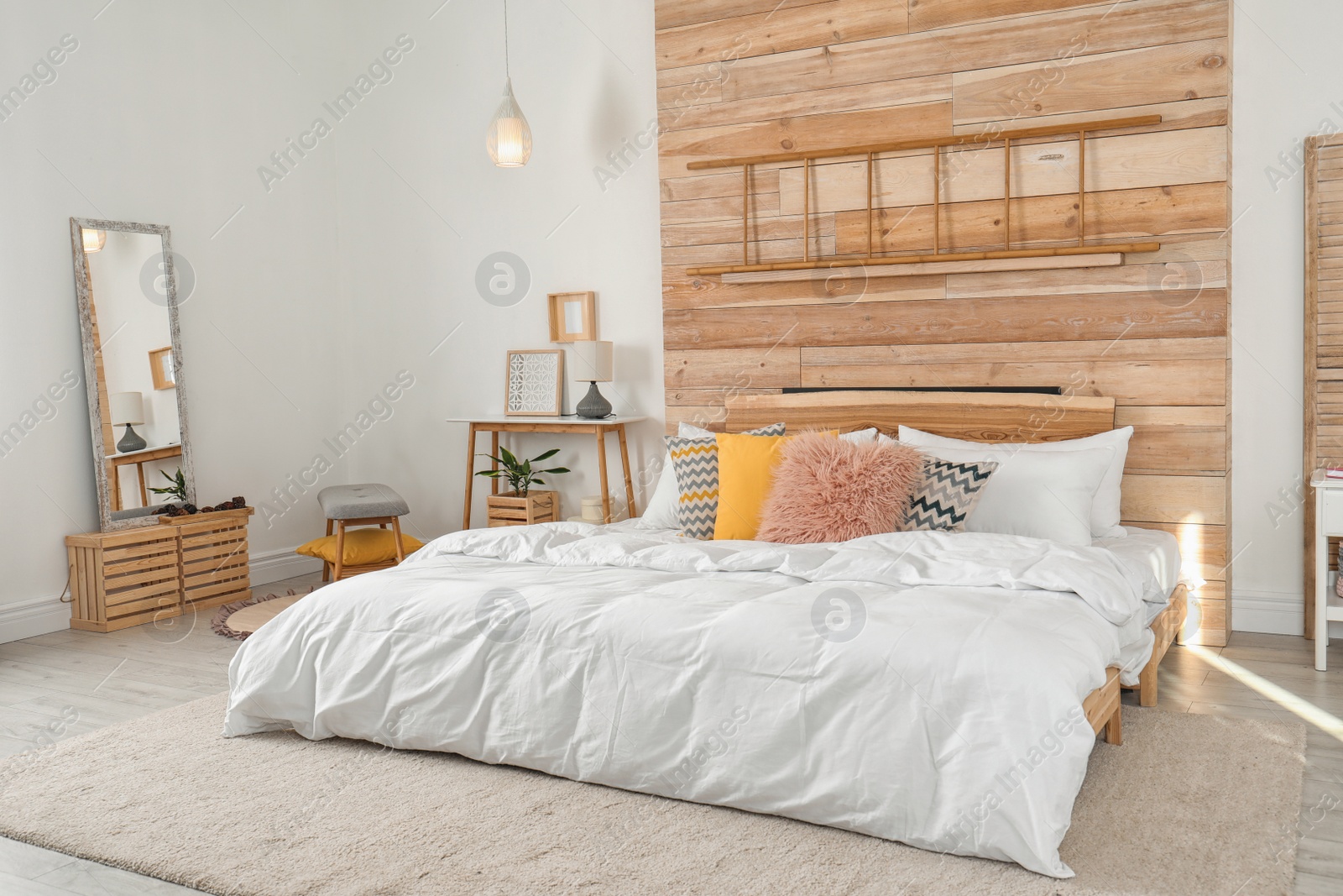 Photo of Stylish room interior with comfortable bed near wooden wall