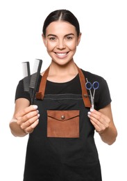 Photo of Portrait of happy hairdresser with professional scissors and combs on white background