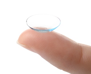 Photo of woman holding contact lens on light background, closeup