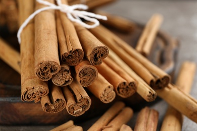 Photo of Tied aromatic brown cinnamon sticks, closeup view