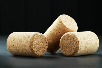 Photo of Corks of wine bottles on grey table, closeup