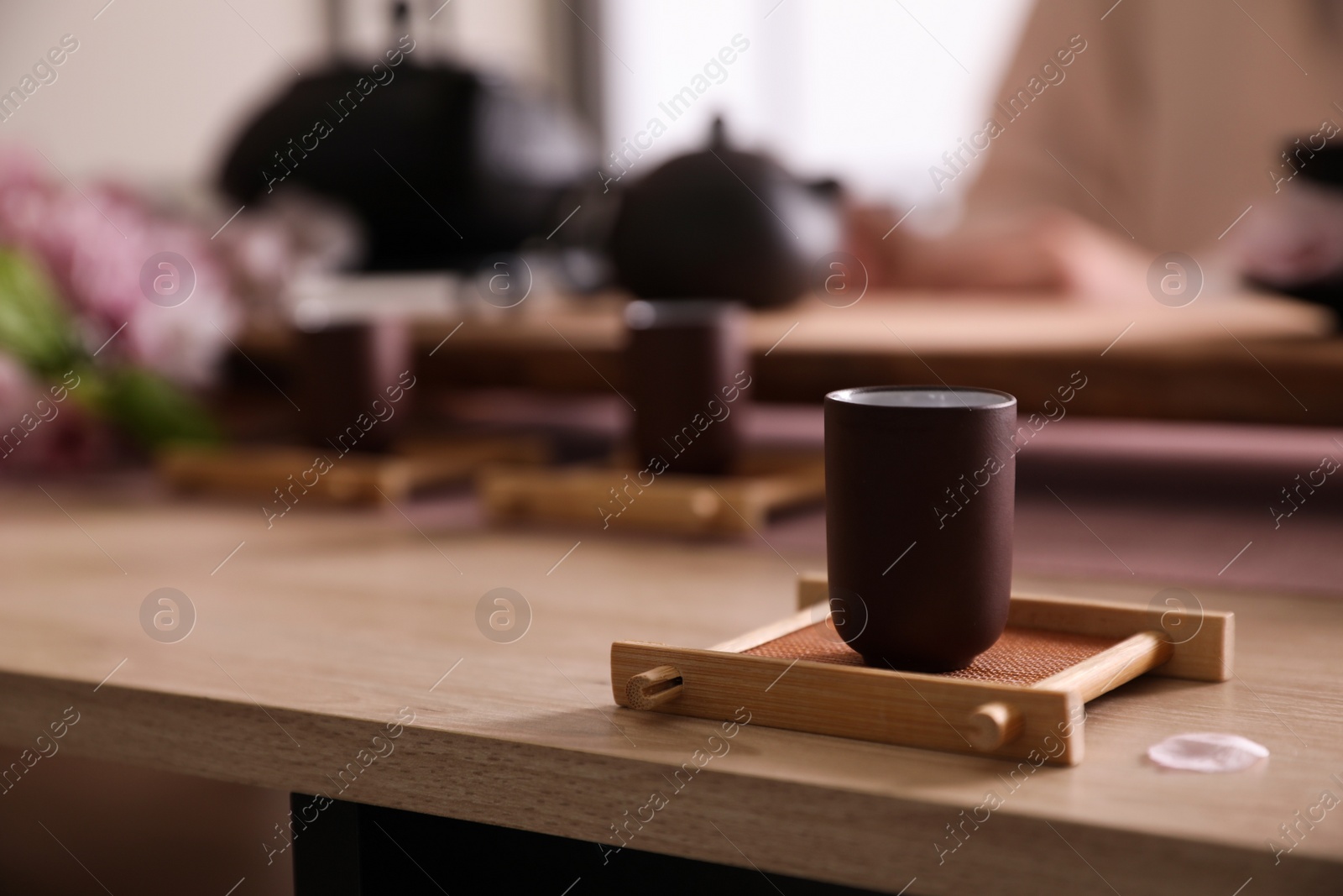 Photo of Cup for traditional tea ceremony on wooden table