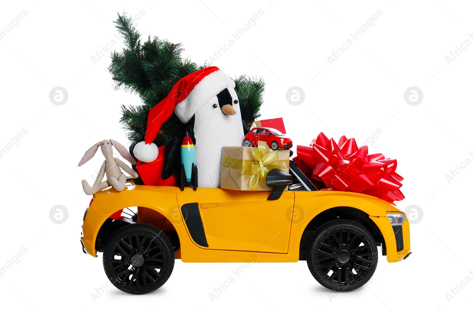 Photo of Child's electric car with toys, gift boxes and Christmas decor on white background