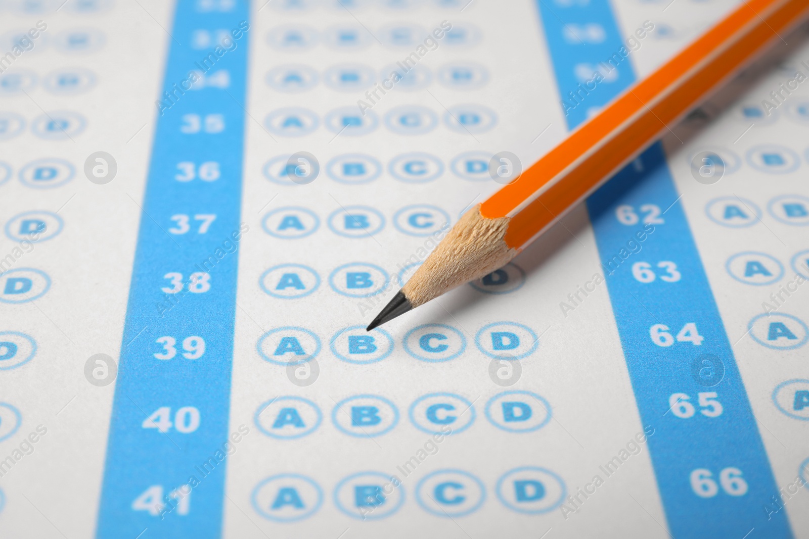 Photo of Pencil on answer sheet, closeup. Student passing exam