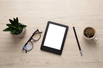 Photo of Modern e-book reader, plant, glasses and coffee on white wooden table, flat lay