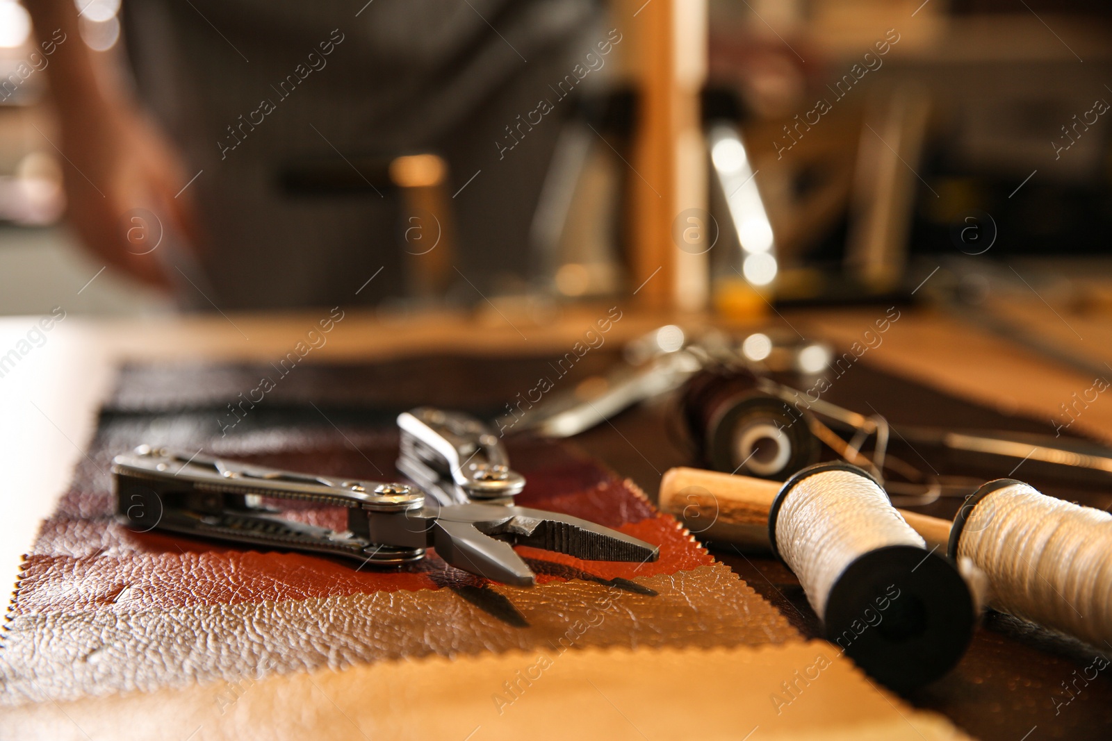 Photo of Tools for leather working on desk in workshop