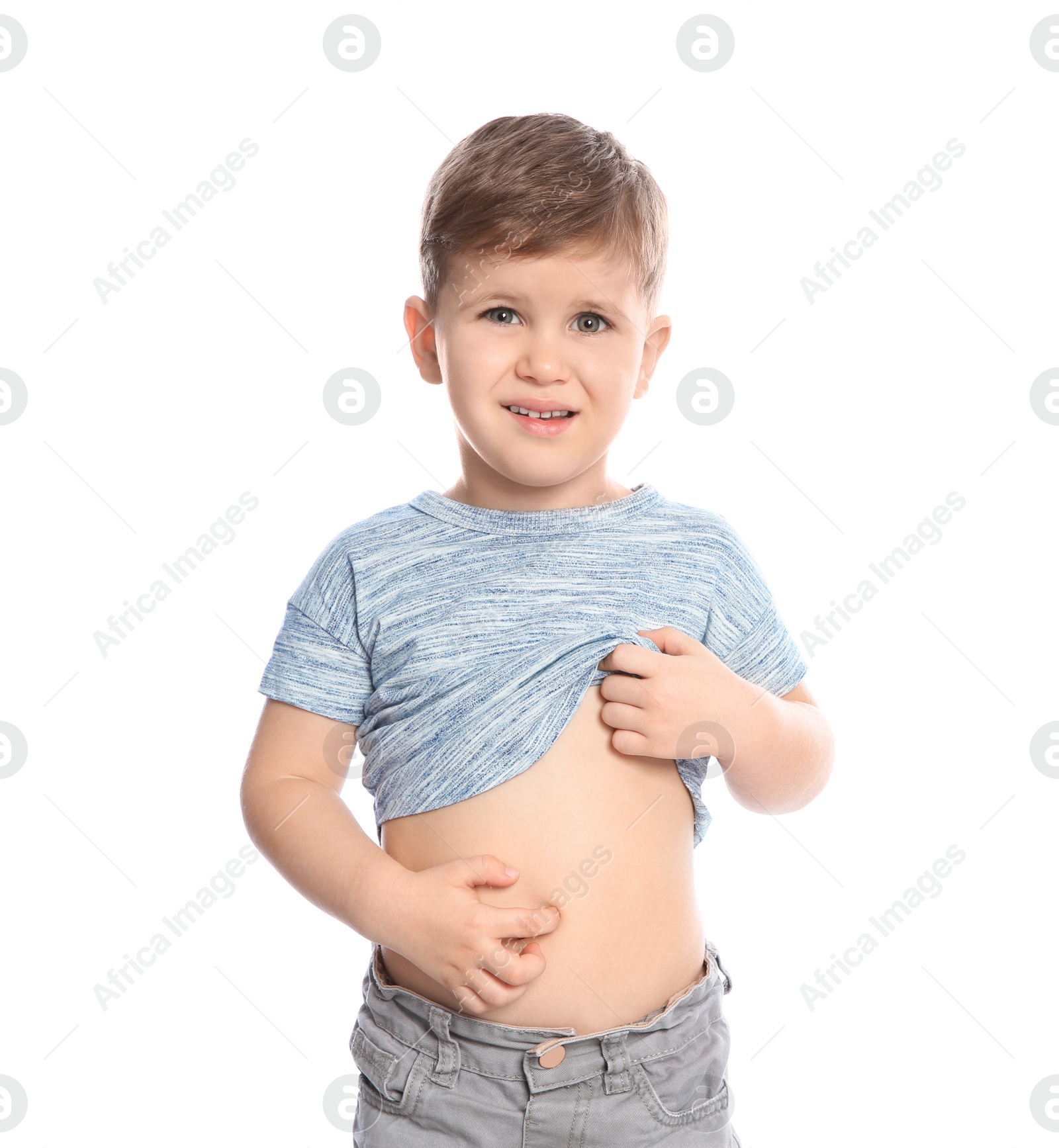 Photo of Little boy scratching belly on white background. Annoying itch