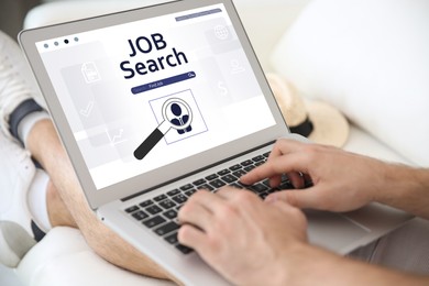 Image of Man working with modern laptop indoors, closeup. Job search